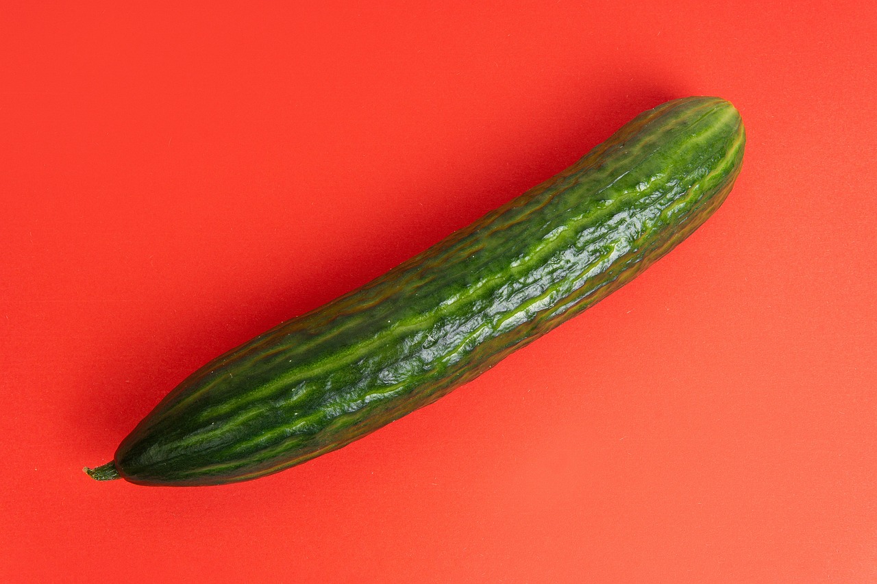 Cetrioli freschi su un tagliere con un coltello, evidenziando un errore comune nella preparazione.